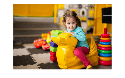 Child playing in a soft play area