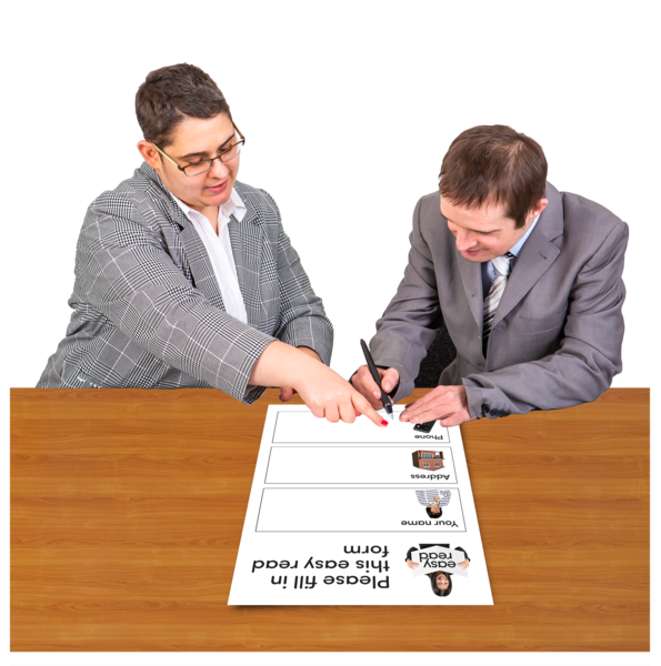 Two people in suits helping each other fill in forms