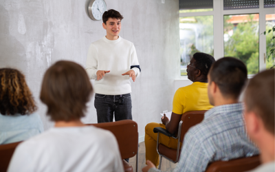 Students listening to speaker in classroom 