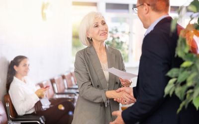 Lady shaking a man's hand