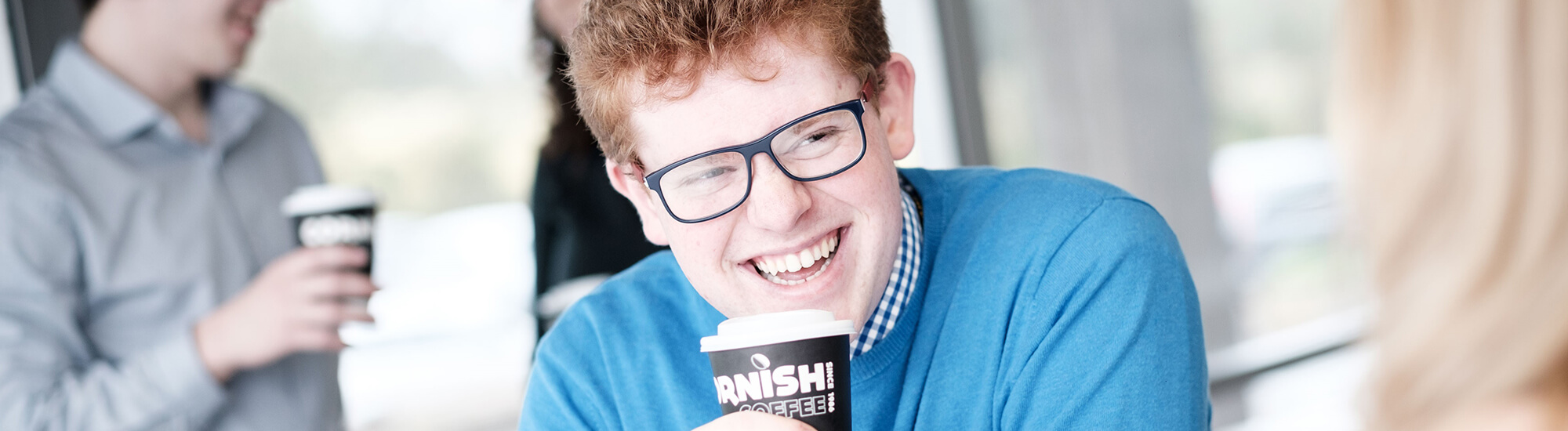 Person smiling drinking coffee