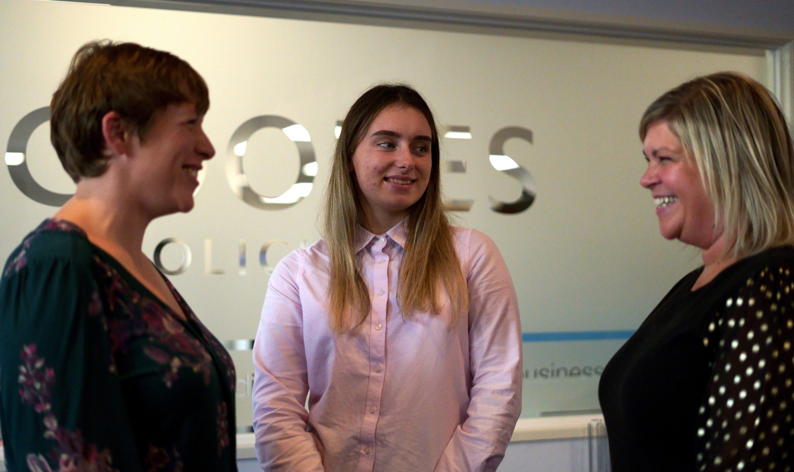 Three people stood inside of Coodes Solicitors