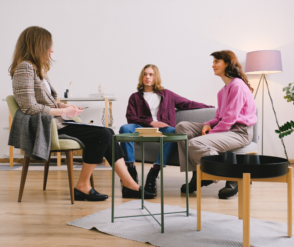 Three people sat down chatting