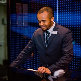 Man stood behind a reception desk